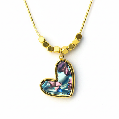 Abalone Heart Pendant Necklace – macro close-up of iridescent abalone shell heart and gold frame