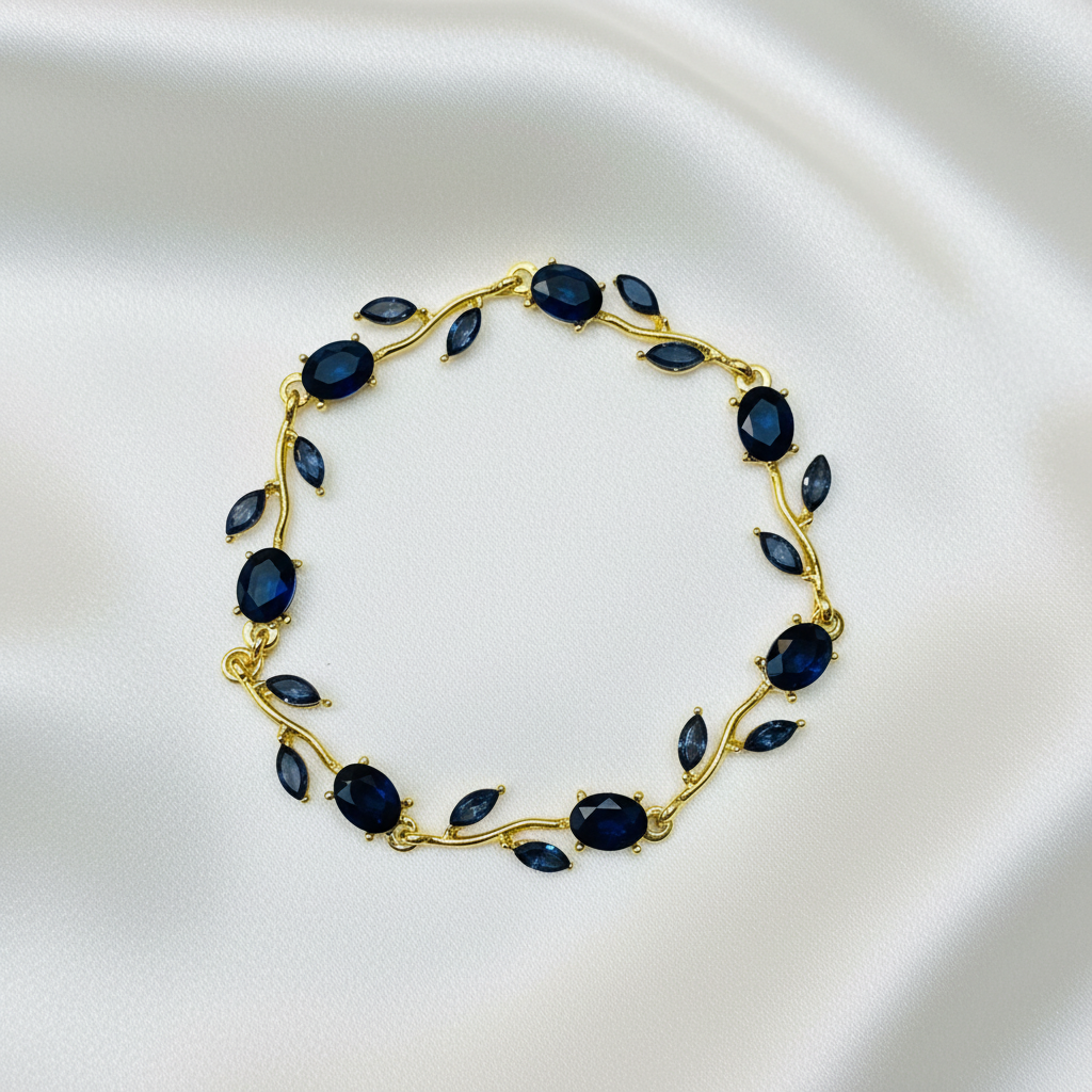 Sapphire Vine Bracelet flat lay on white silk