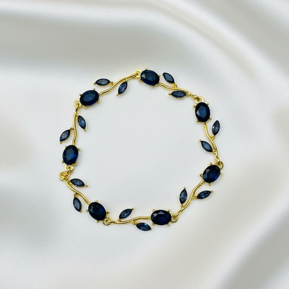 Sapphire Vine Bracelet flat lay on white silk