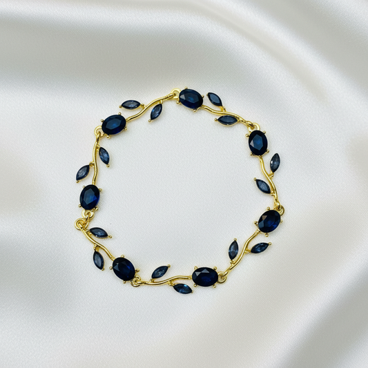 Sapphire Vine Bracelet flat lay on white silk