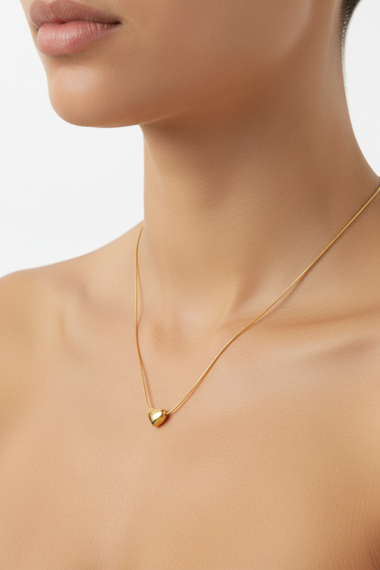 Model wearing Mini Amora Heart Gold Pendant on neck and collarbone