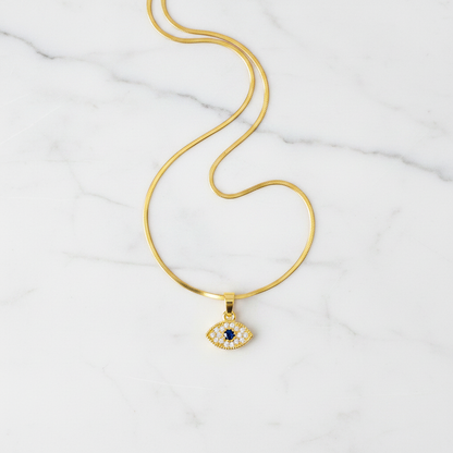 Evil Eye Pendant Necklace - flat lay on white marble