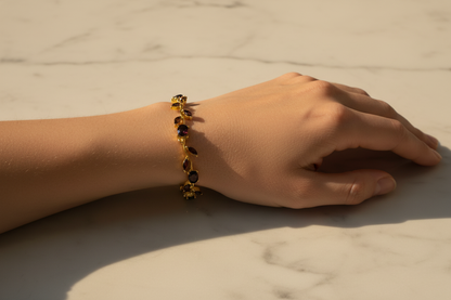 Close-up of Garnet Tulip Bracelet on wrist over marble