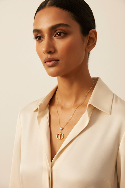 Double Oval Signature Necklace – model wearing gold logo pendant necklace, lifestyle shot