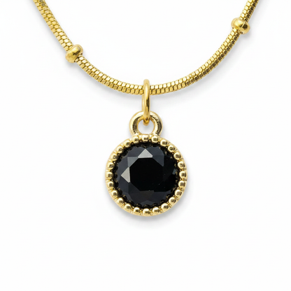 Black Onyx Halo Satellite Necklace – macro close-up of black onyx pendant and gold beaded halo