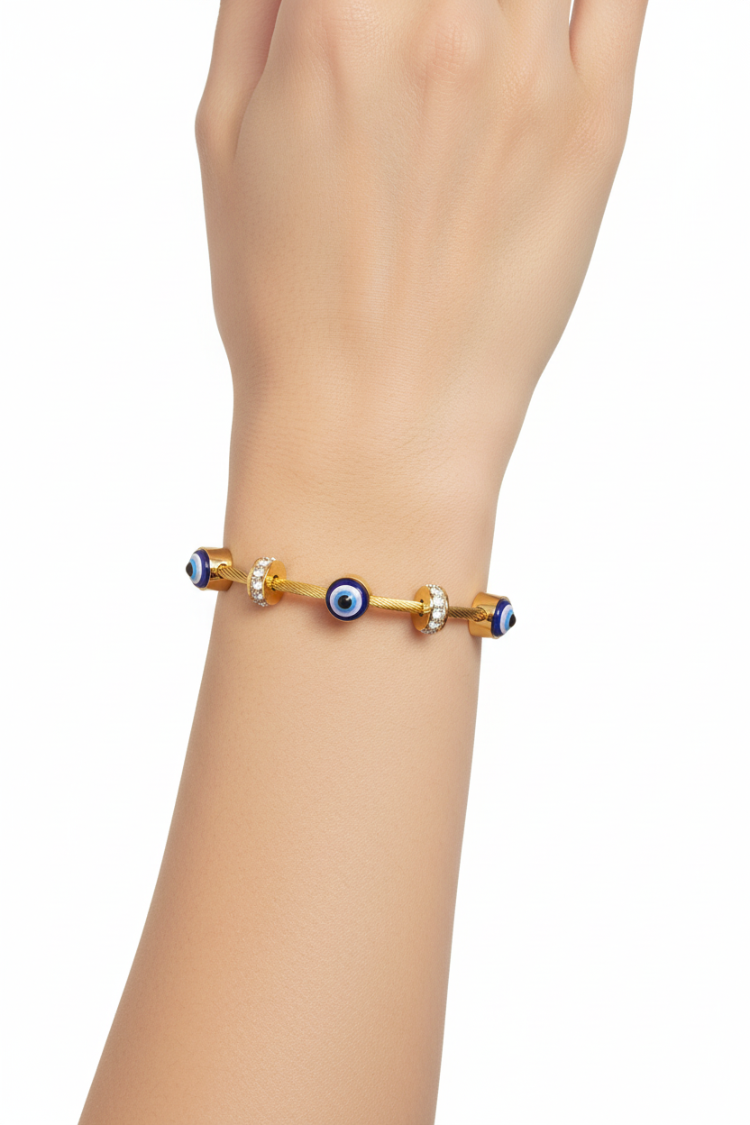 Model wearing gold evil eye bangle bracelet