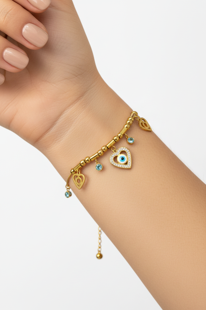 Model wearing gold heart evil eye charm bracelet