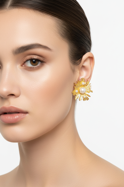Model wearing gold pearl sunburst earrings